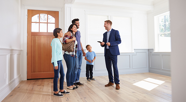 Realtor showing a family around a prospective new home